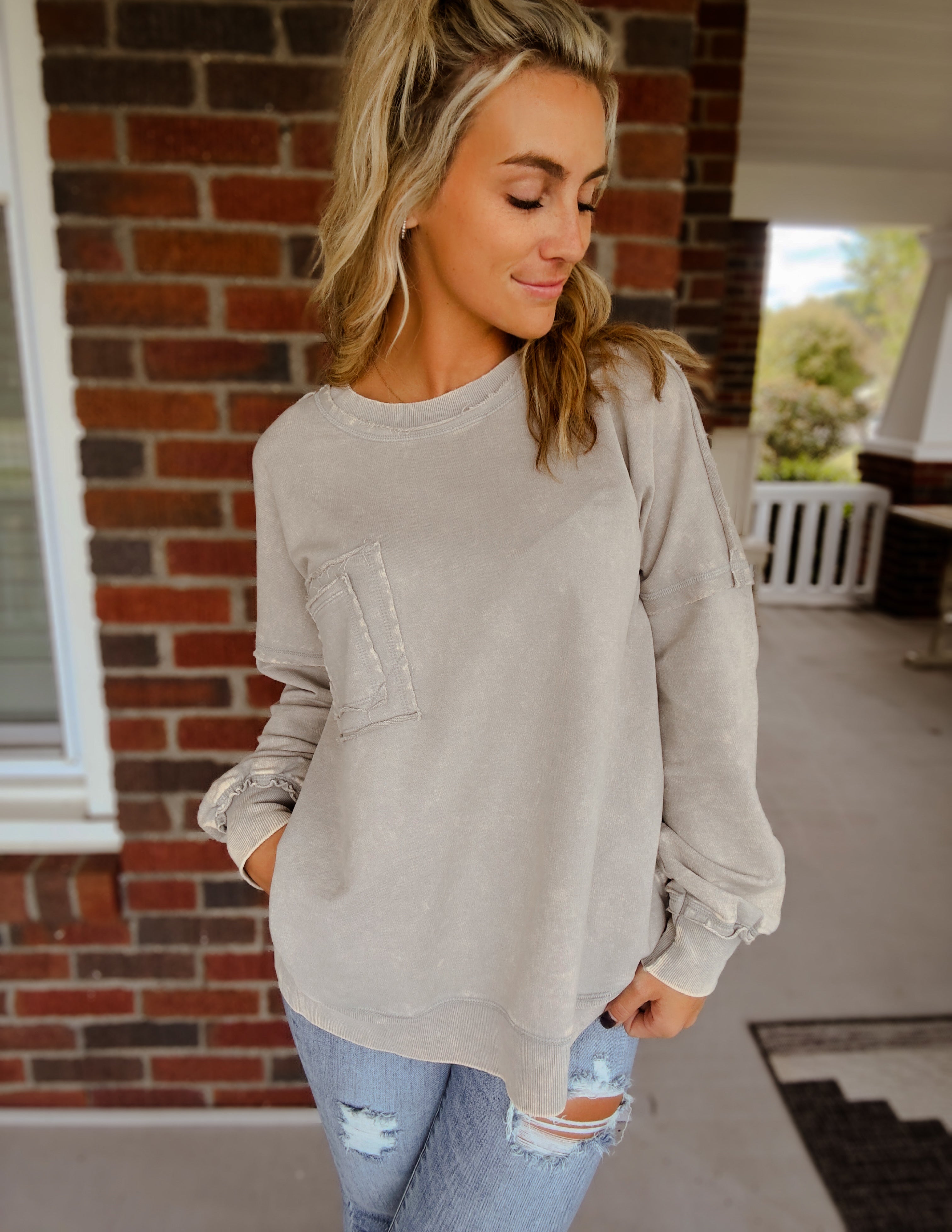 Acid wash raw edge front pocket pullover