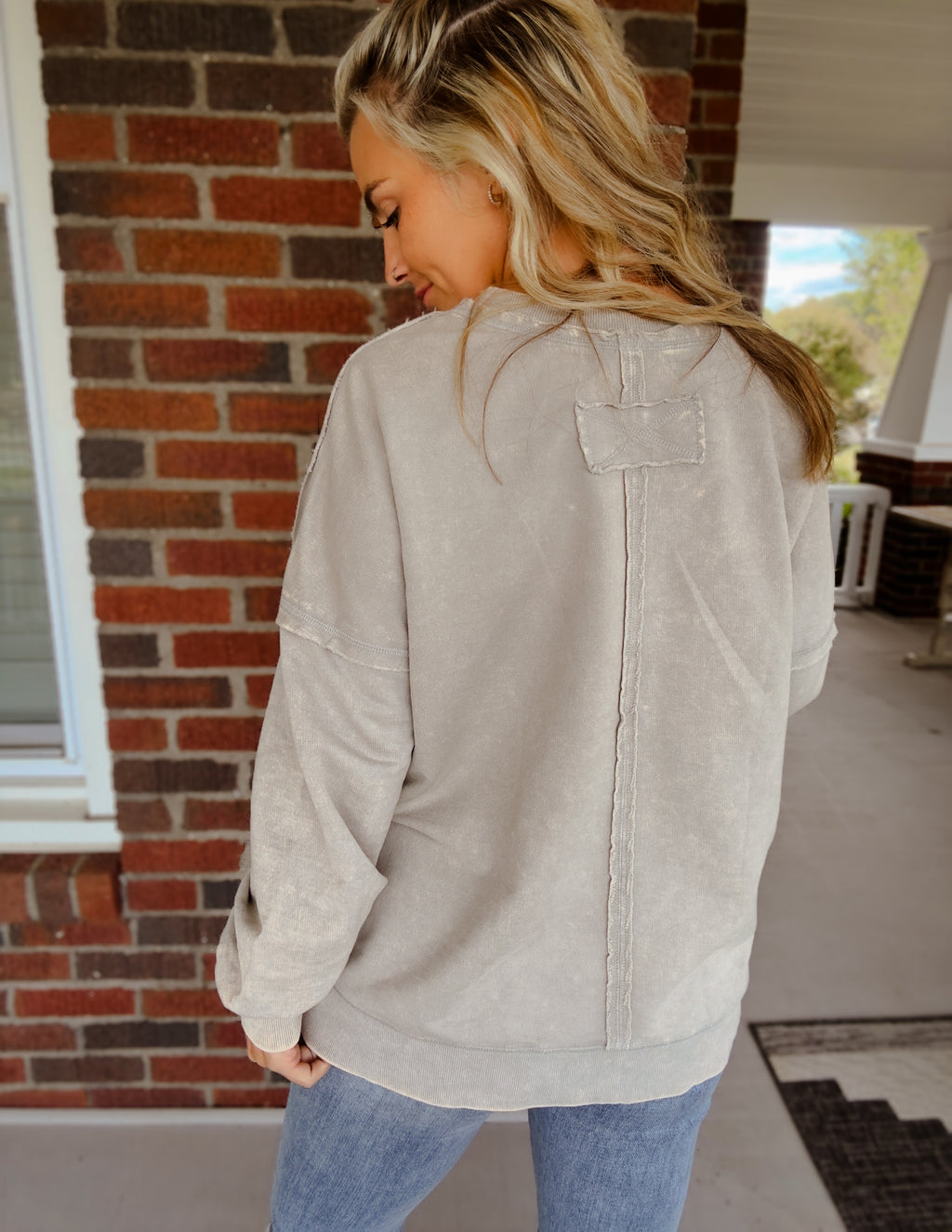 Acid wash raw edge front pocket pullover