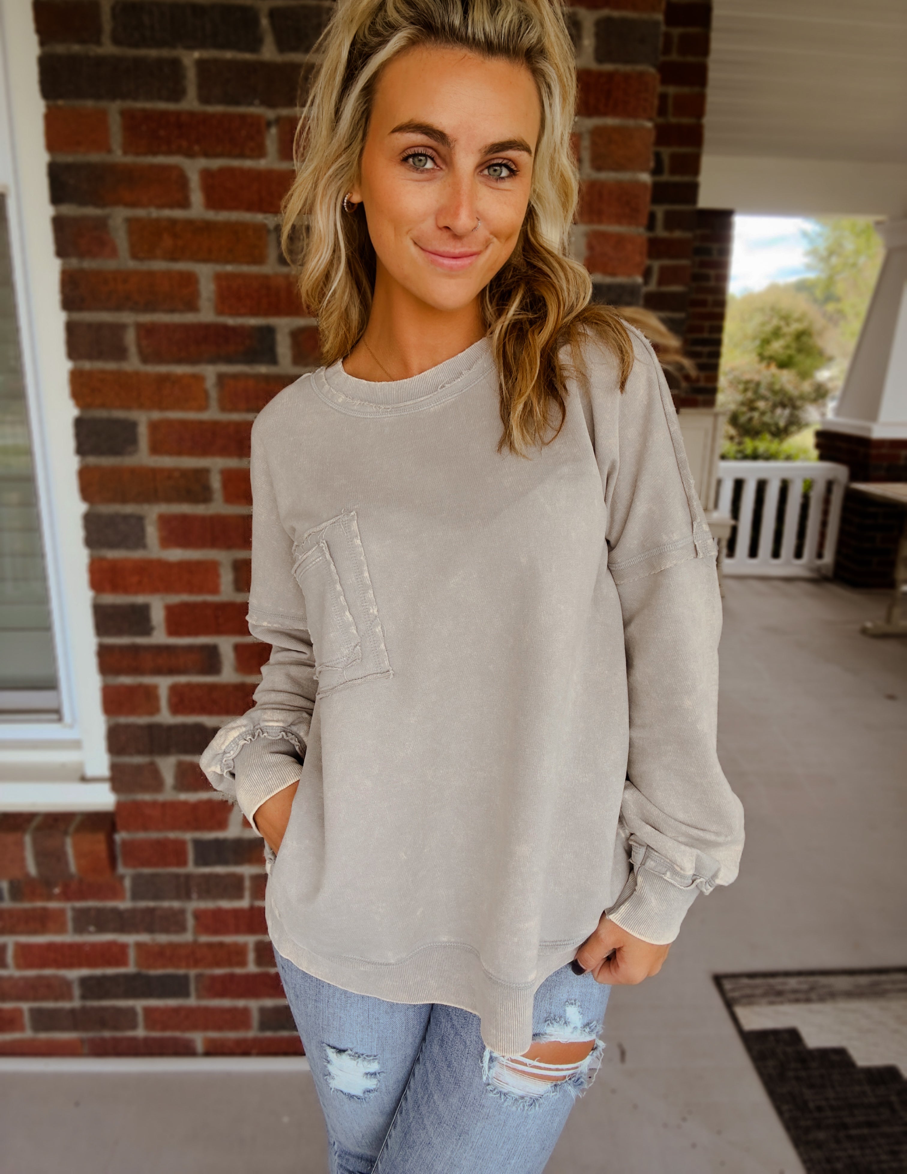 Acid wash raw edge front pocket pullover