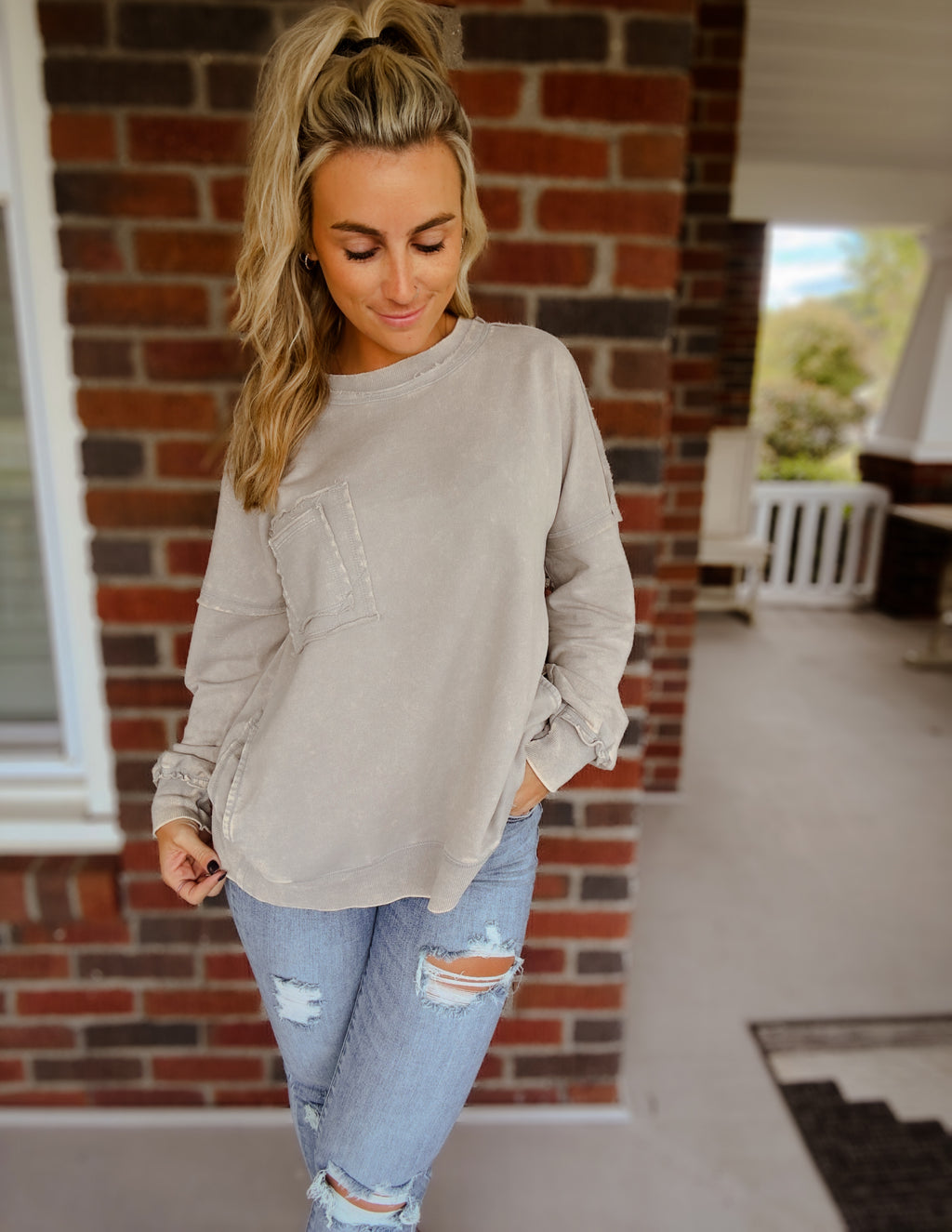 Acid wash raw edge front pocket pullover